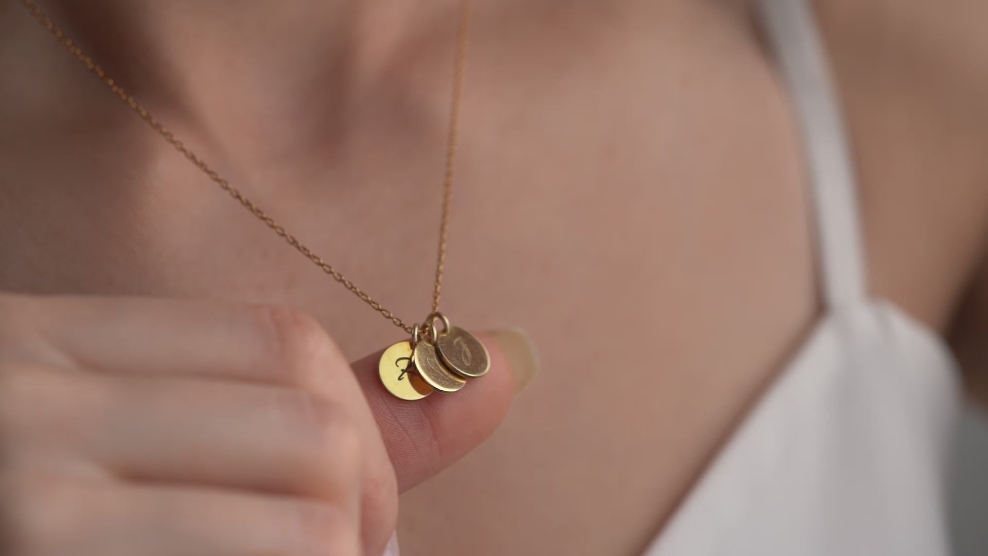 Women showing our beautiful coin necklace with names and initial engraved on